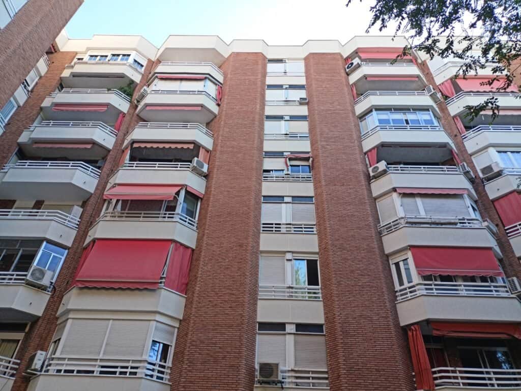Edificio de apartamentos con toldos rojos.